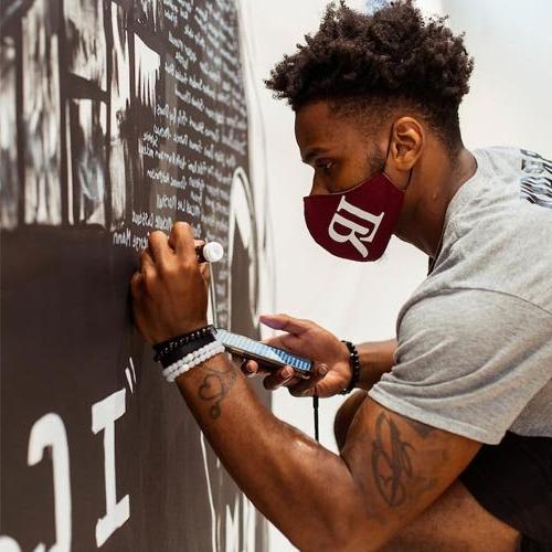 Amari Brown painting Black Lives Matter mural